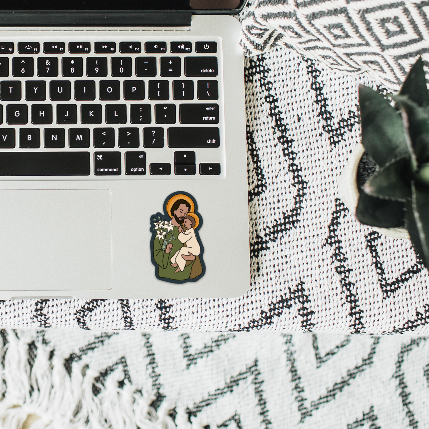 a laptop computer sitting on top of a white blanket