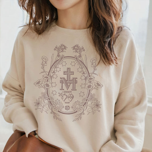 a woman wearing a sweatshirt with a cross on it