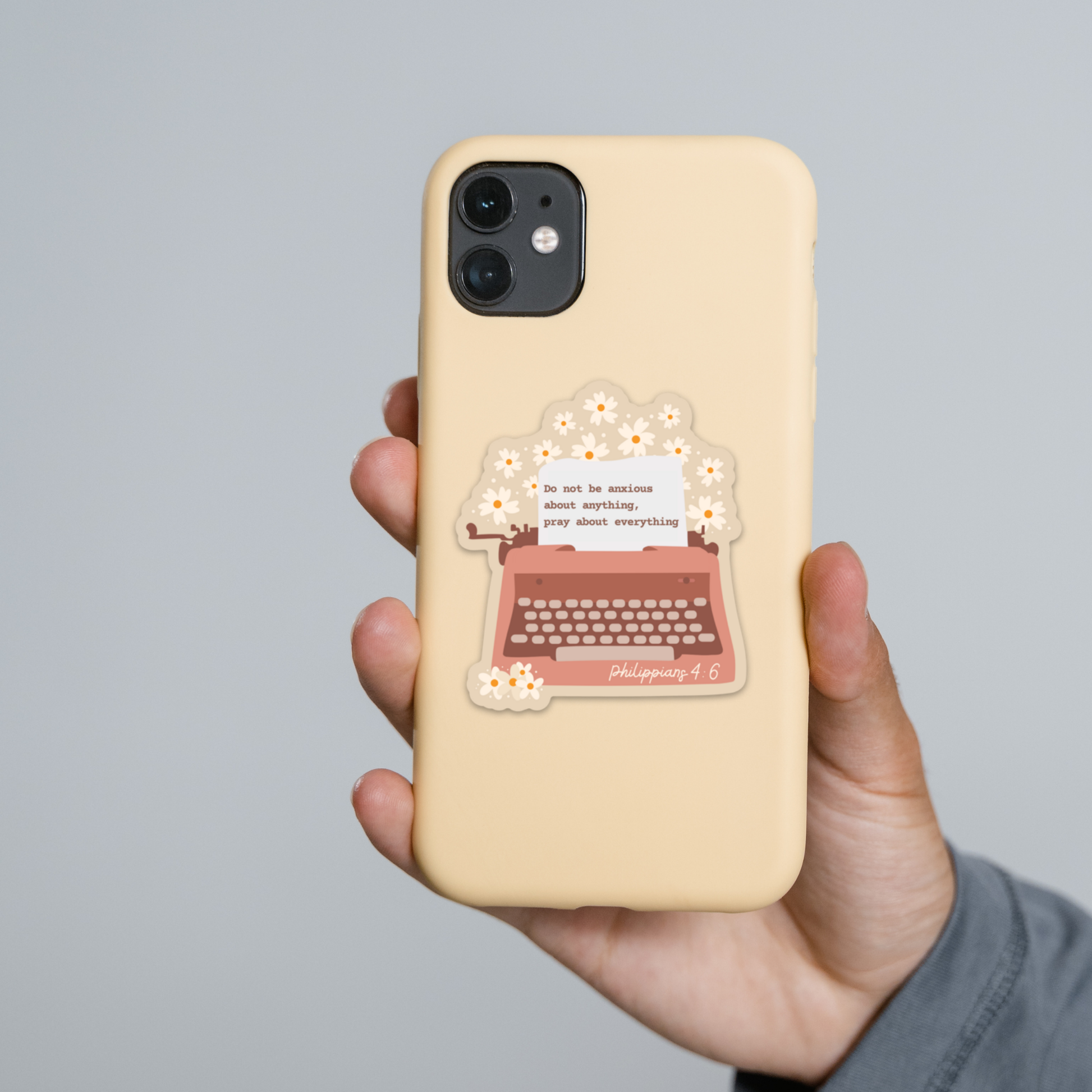 a person holding a phone case with a typewriter on it