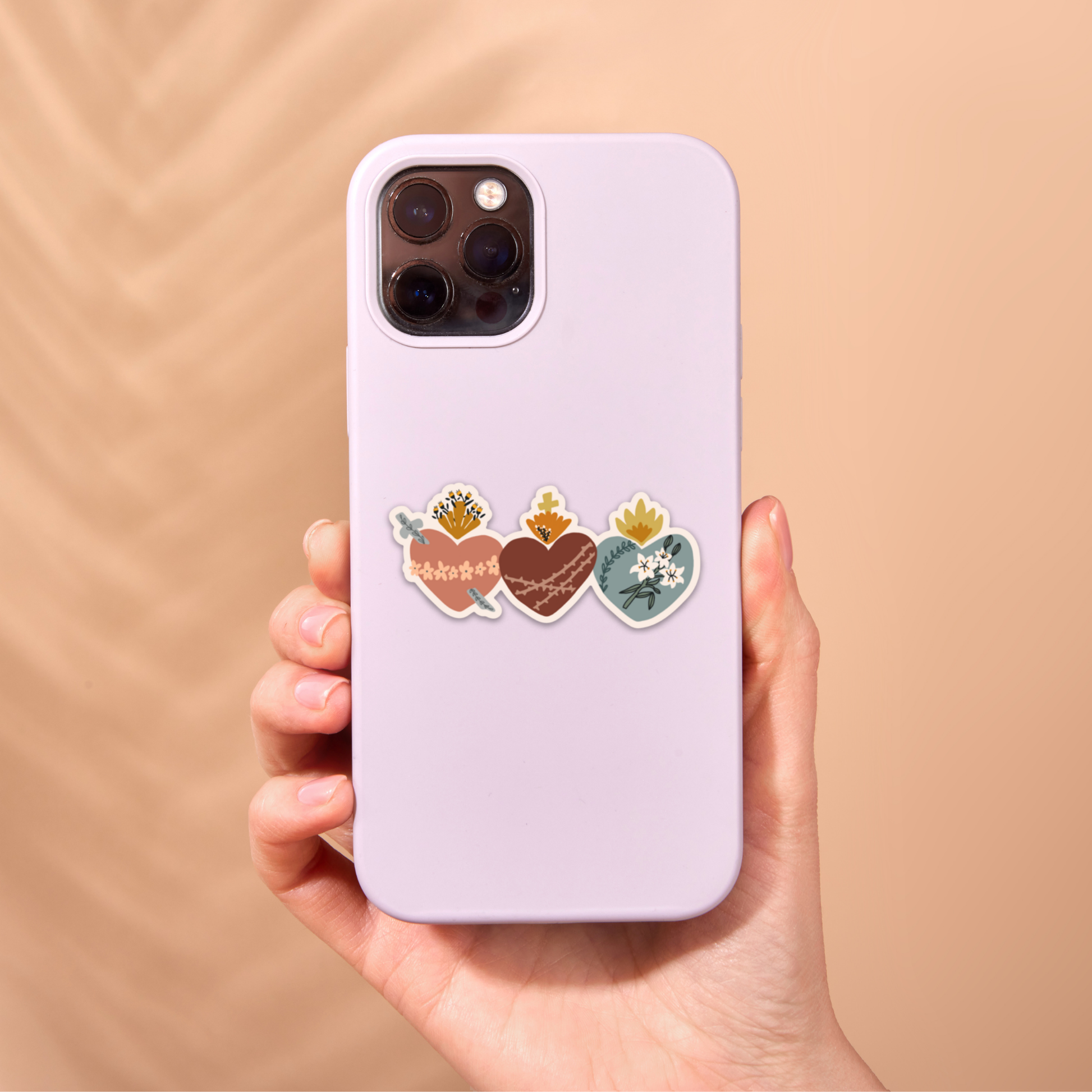 a person holding a phone case with stickers on it