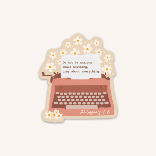 a sticker with a typewriter and flowers on it